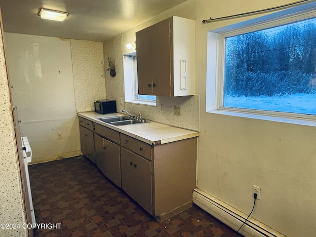 4312 E 6th Ave, Anchorage, AK 99508 - kitchen featuring a sink, a baseboard radiator, and light countertops