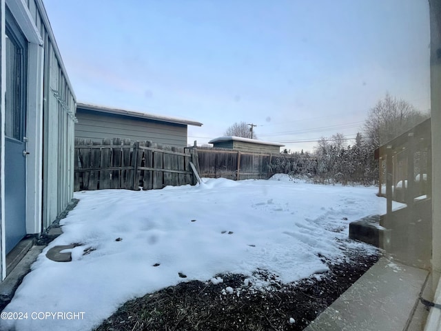 4312 E 6th Ave, Anchorage, AK 99508 - snowy yard featuring a fenced backyard