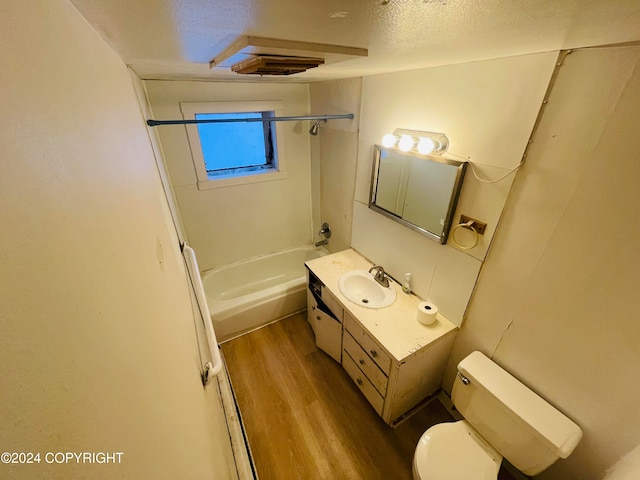 full bathroom with vanity, bathing tub / shower combination, hardwood / wood-style flooring, toilet, and a textured ceiling