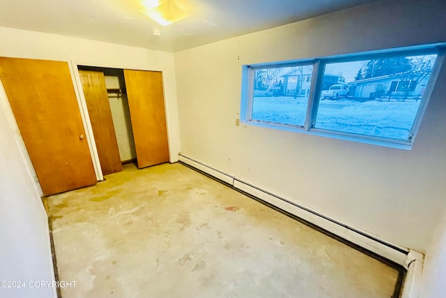 unfurnished bedroom featuring a closet and baseboard heating