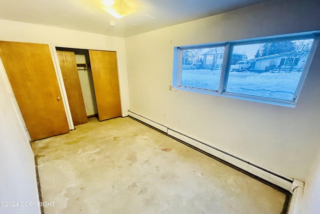 4312 E 6th Ave, Anchorage, AK 99508 - unfurnished bedroom with baseboard heating, concrete floors, and a closet