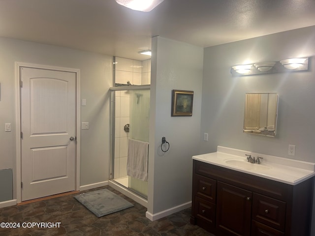 bathroom with walk in shower and vanity