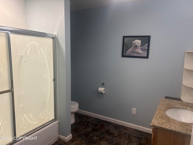 full bathroom with bath / shower combo with glass door, vanity, and toilet