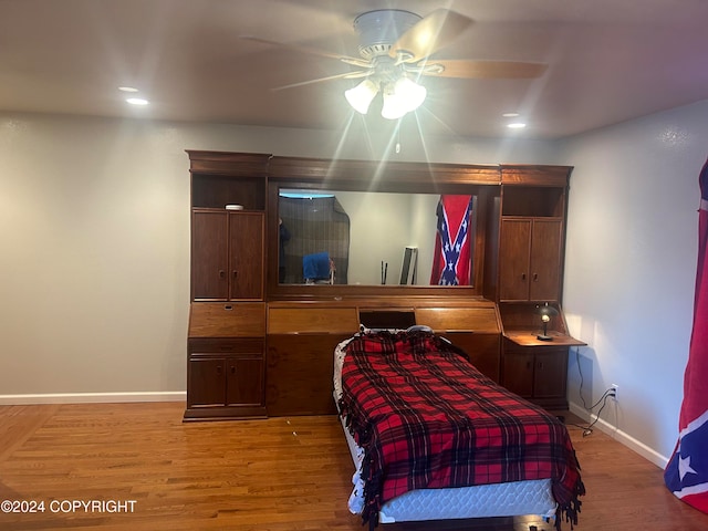 bedroom with hardwood / wood-style floors and ceiling fan