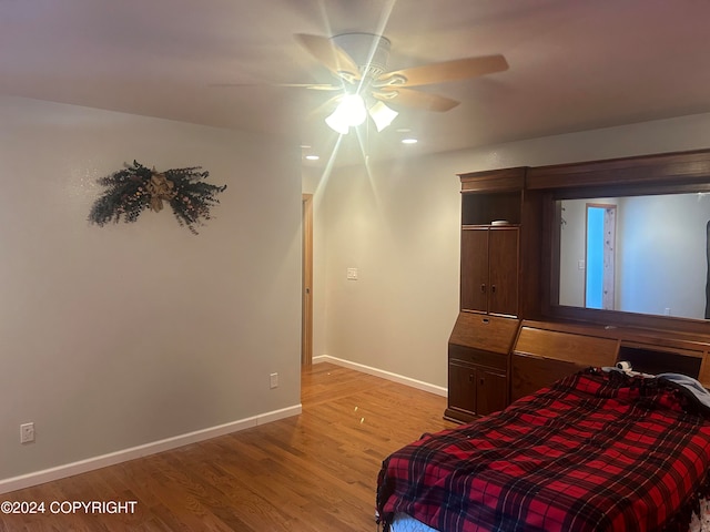 bedroom featuring light wood-type flooring and ceiling fan