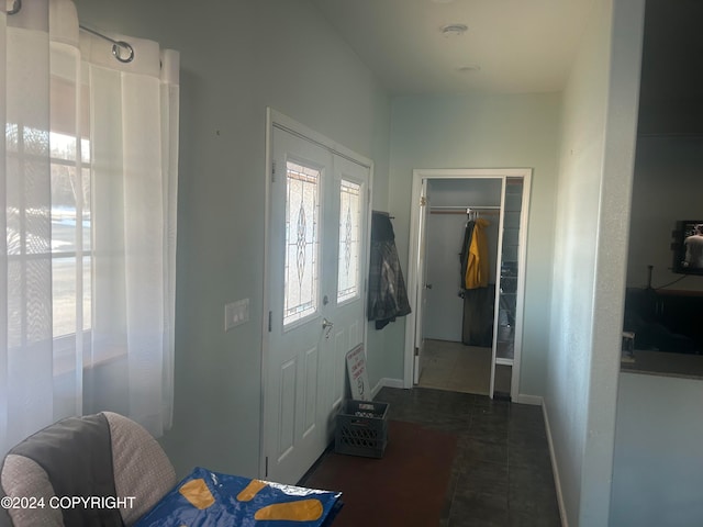 entryway featuring dark tile patterned flooring