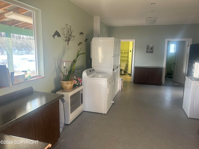 laundry room with stacked washer / drying machine