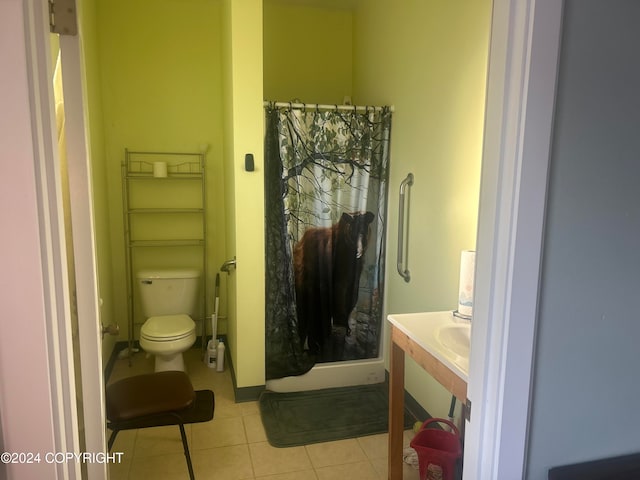 bathroom with toilet, tile patterned flooring, and a shower with shower curtain