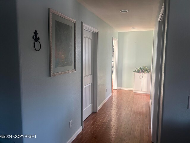 hall with hardwood / wood-style floors