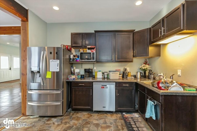 kitchen featuring stainless steel appliances and dark brown cabinetry