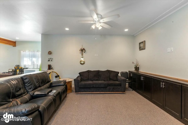 carpeted living room featuring ornamental molding and ceiling fan