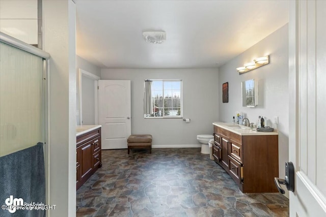 bathroom with vanity, toilet, and walk in shower