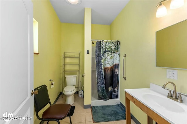 bathroom with tile patterned flooring, vanity, toilet, and walk in shower