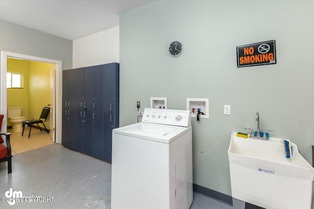 clothes washing area with sink and washer / dryer