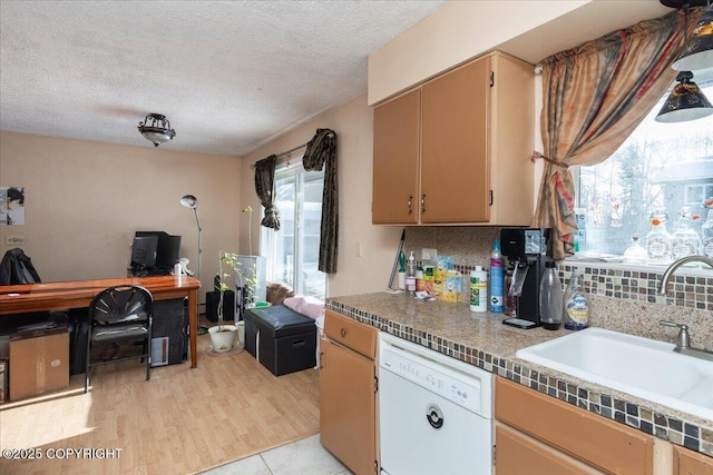 kitchen featuring decorative backsplash, dishwasher, a textured ceiling, and a sink