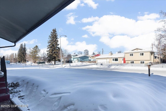 snowy yard with fence