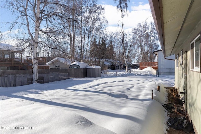 snowy yard with fence