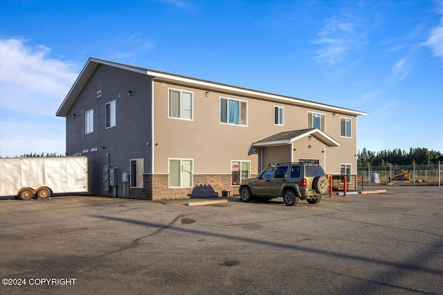3462 S Big Lake Rd, Big Lake, AK 99623 - back of property featuring uncovered parking, stone siding, and fence