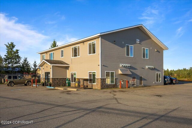 3462 S Big Lake Rd, Big Lake, AK 99623 - back of property featuring uncovered parking and stone siding