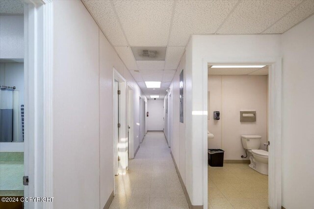 3462 S Big Lake Rd, Big Lake, AK 99623 - hallway featuring a drop ceiling, light floors, and baseboards