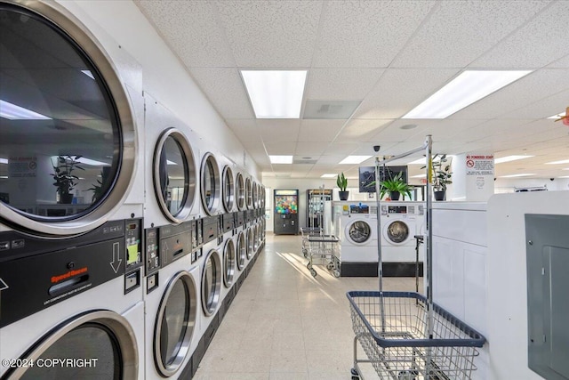 washroom featuring electric panel, washer and clothes dryer, and stacked washer / dryer