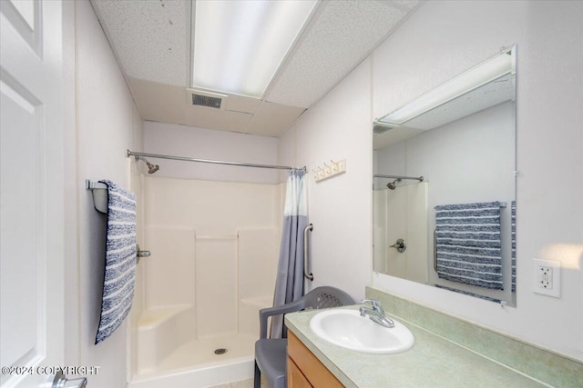 bathroom featuring vanity and a shower with shower curtain