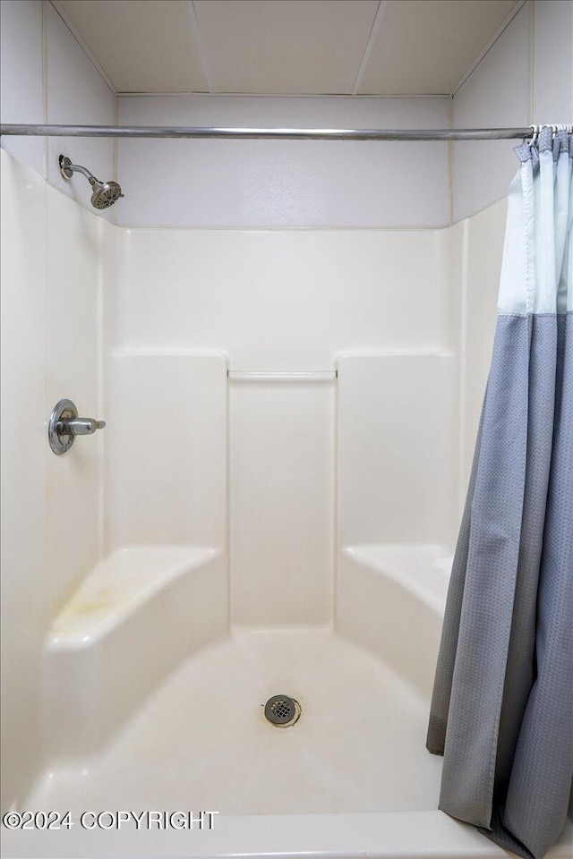 bathroom with a shower with curtain