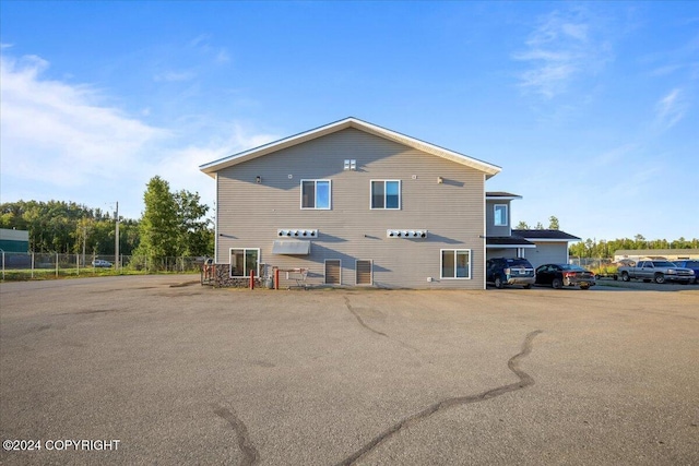 3462 S Big Lake Rd, Big Lake, AK 99623 - rear view of house featuring uncovered parking and fence