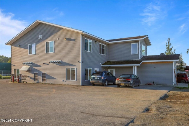 rear view of property with a garage