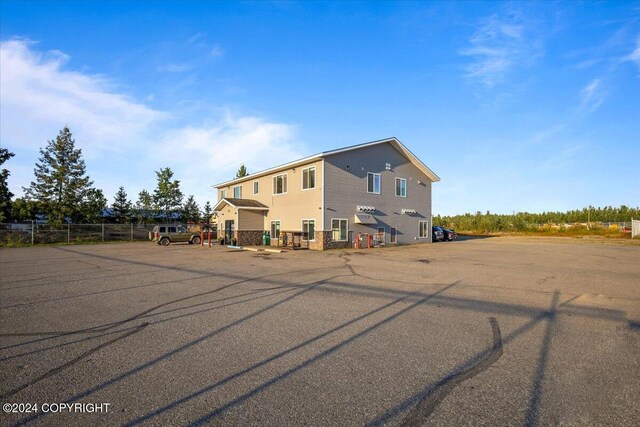 3462 S Big Lake Rd, Big Lake, AK 99623 - rear view of property with uncovered parking and fence