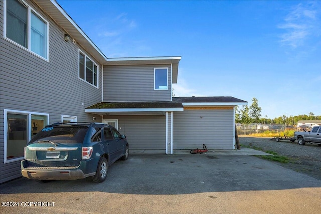 rear view of property featuring a garage