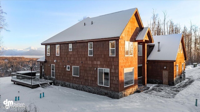 view of snow covered exterior featuring a mountain view