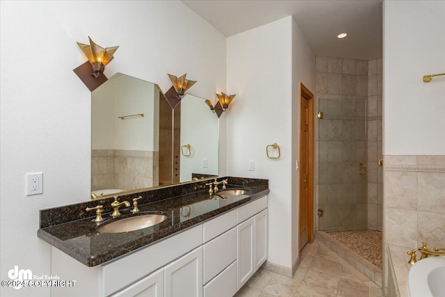 bathroom with tile patterned flooring, shower with separate bathtub, and vanity