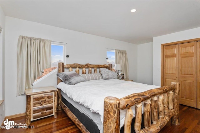 bedroom with dark hardwood / wood-style floors