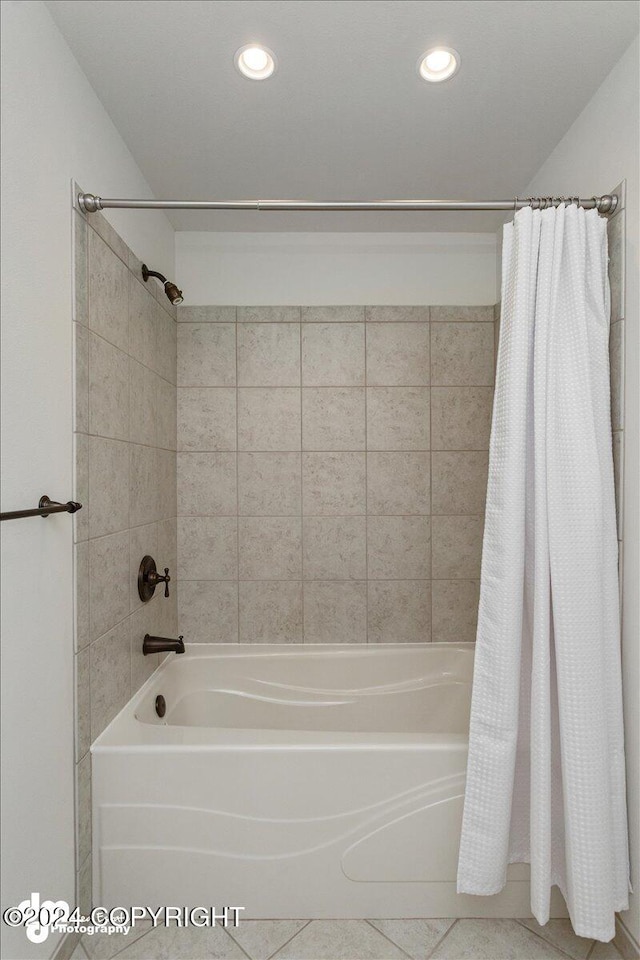 bathroom with tile patterned floors and shower / tub combo with curtain