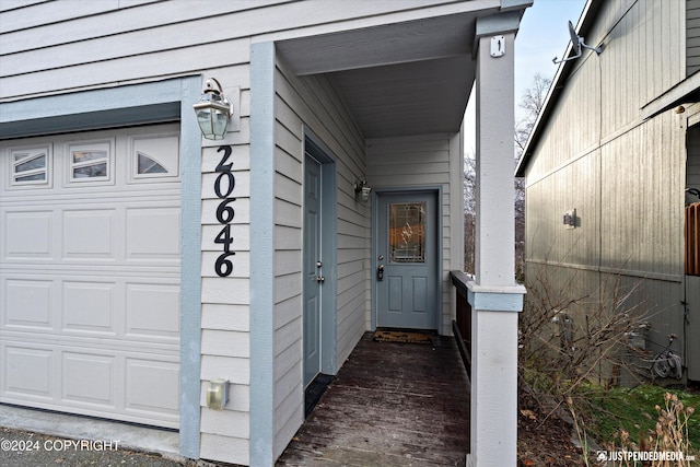 doorway to property with a garage