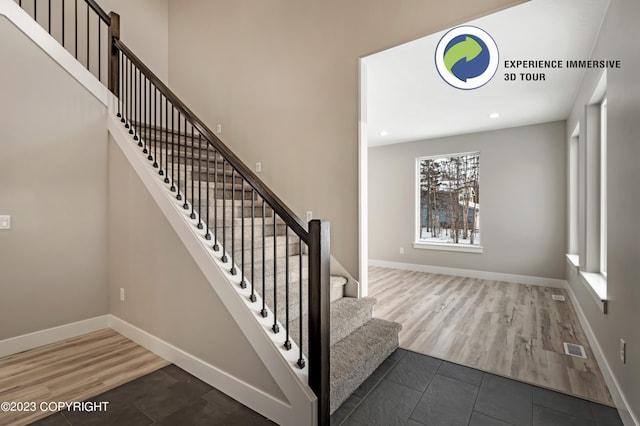 stairway with hardwood / wood-style floors