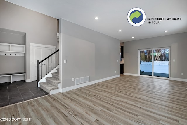 unfurnished living room with wood-type flooring