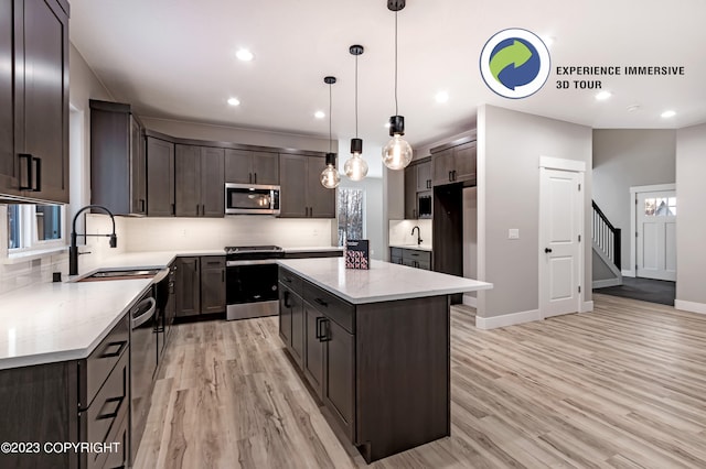 kitchen with dark brown cabinets, a center island, stainless steel appliances, and hanging light fixtures