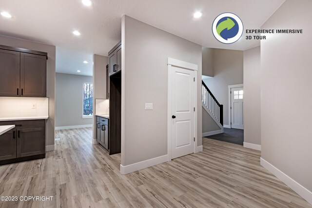 hallway with a healthy amount of sunlight and light wood-type flooring