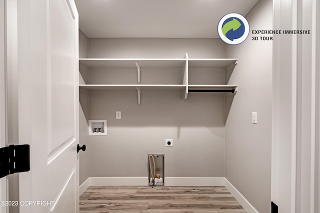 laundry area featuring hookup for a washing machine, light hardwood / wood-style flooring, and hookup for an electric dryer