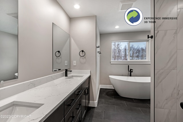 bathroom with vanity and a tub