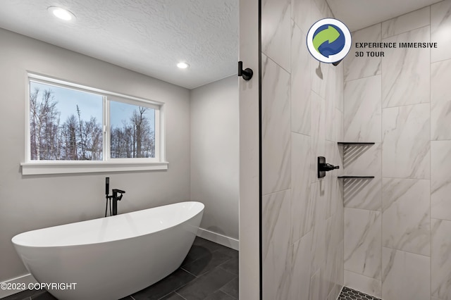 bathroom with a textured ceiling and independent shower and bath