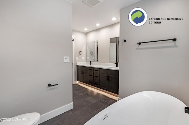 bathroom featuring vanity, toilet, and a tub