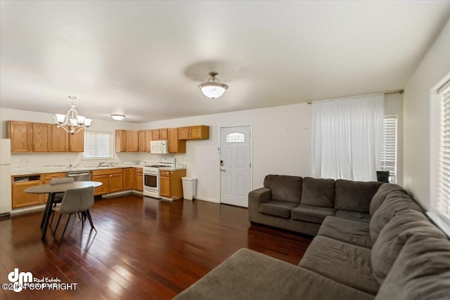 living room with a chandelier, dark hardwood / wood-style flooring, and sink