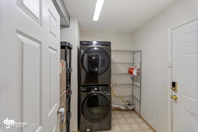 laundry room featuring stacked washer / drying machine