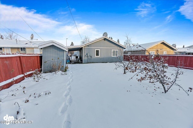 view of snow covered rear of property