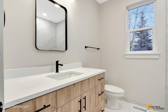 bathroom with toilet and vanity