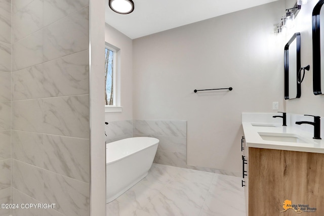 bathroom featuring vanity and a bath