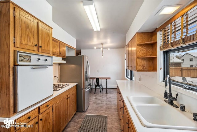 kitchen with white appliances, sink, and plenty of natural light